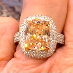 Size 7 champagne cocktail ring with white czs around and down the shank .